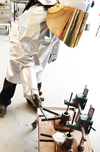 Person in lab coat melting aluminium